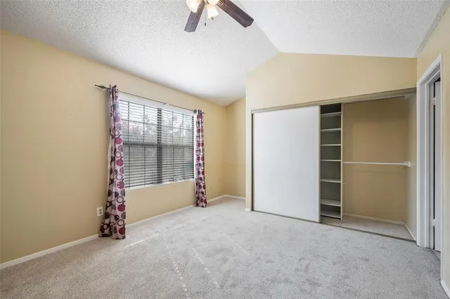 an empty room with windows and closet