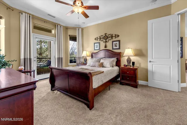a room with chandelier fan and windows