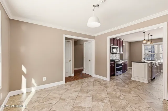 a view of a kitchen with refrigerator and furniture