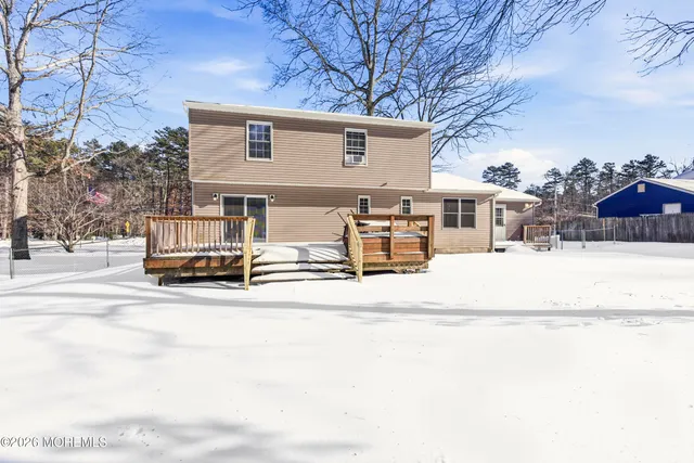 a view of a house with snow on the road