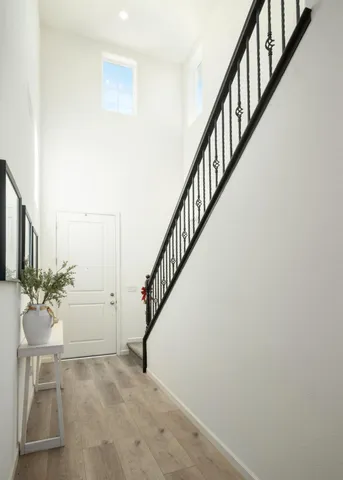 a view of entryway and hall with wooden floor