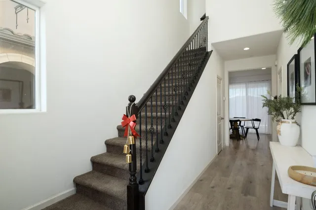 a view of entryway and hall with wooden floor