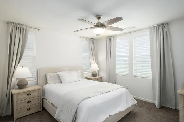 a bedroom with a large bed and a window