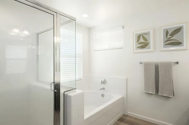 a bathroom with a bathtub and a shower