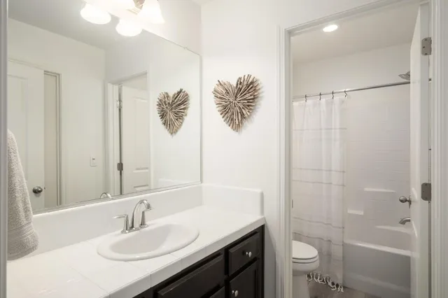 a bathroom with a sink toilet tub and shower