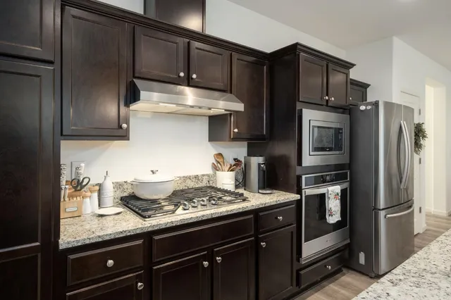 a kitchen with a sink stainless steel appliances and cabinets