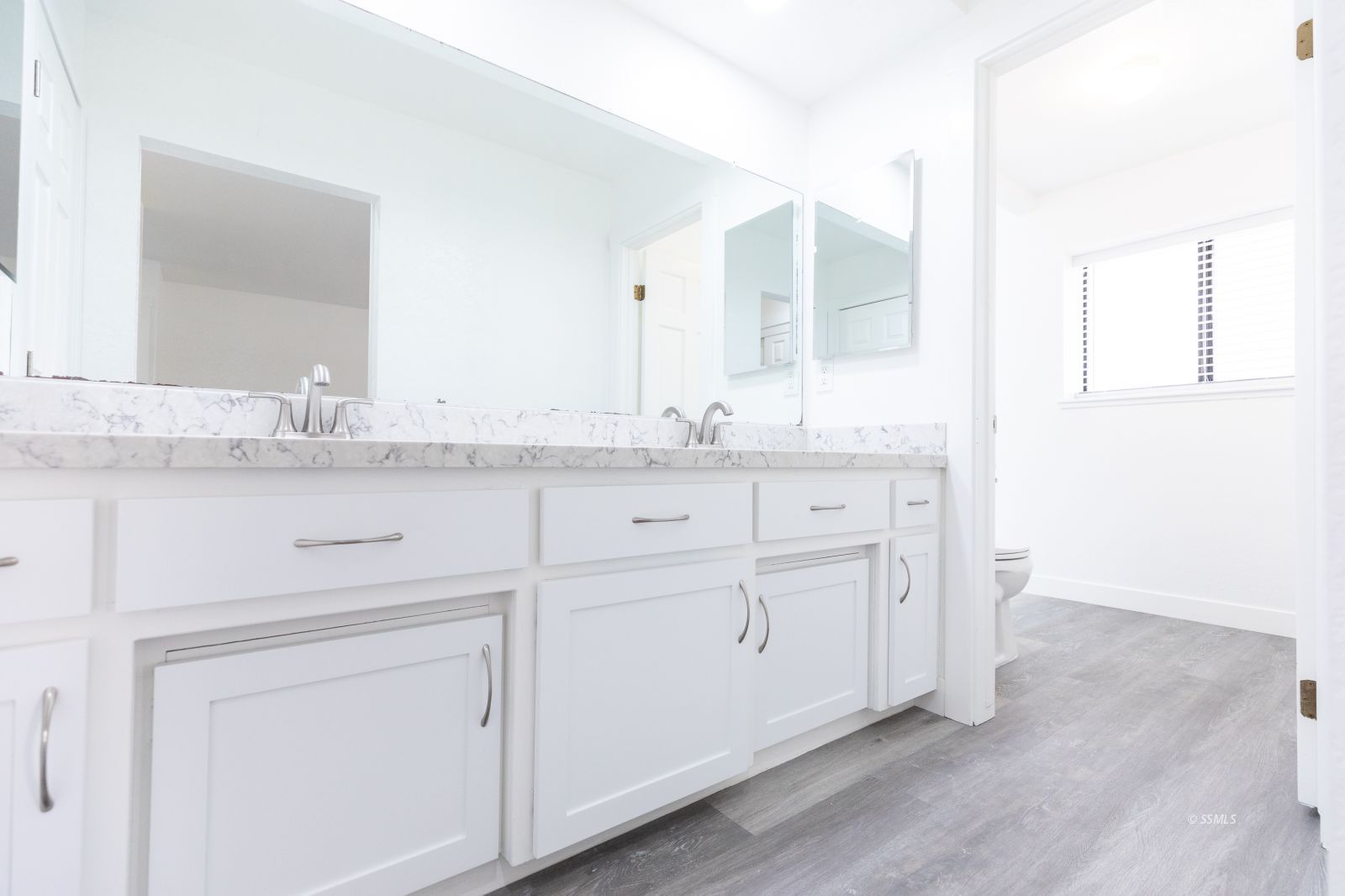 1133 Meadowview Lane Ridgecrest, CA 93555 - Photo 23 of 49 a bathroom with a granite countertop sink and a mirror