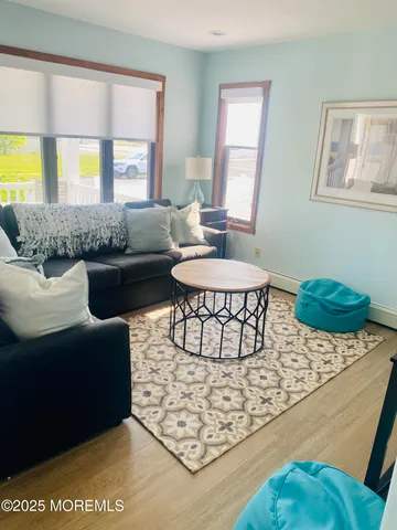 a living room with furniture a window and a table
