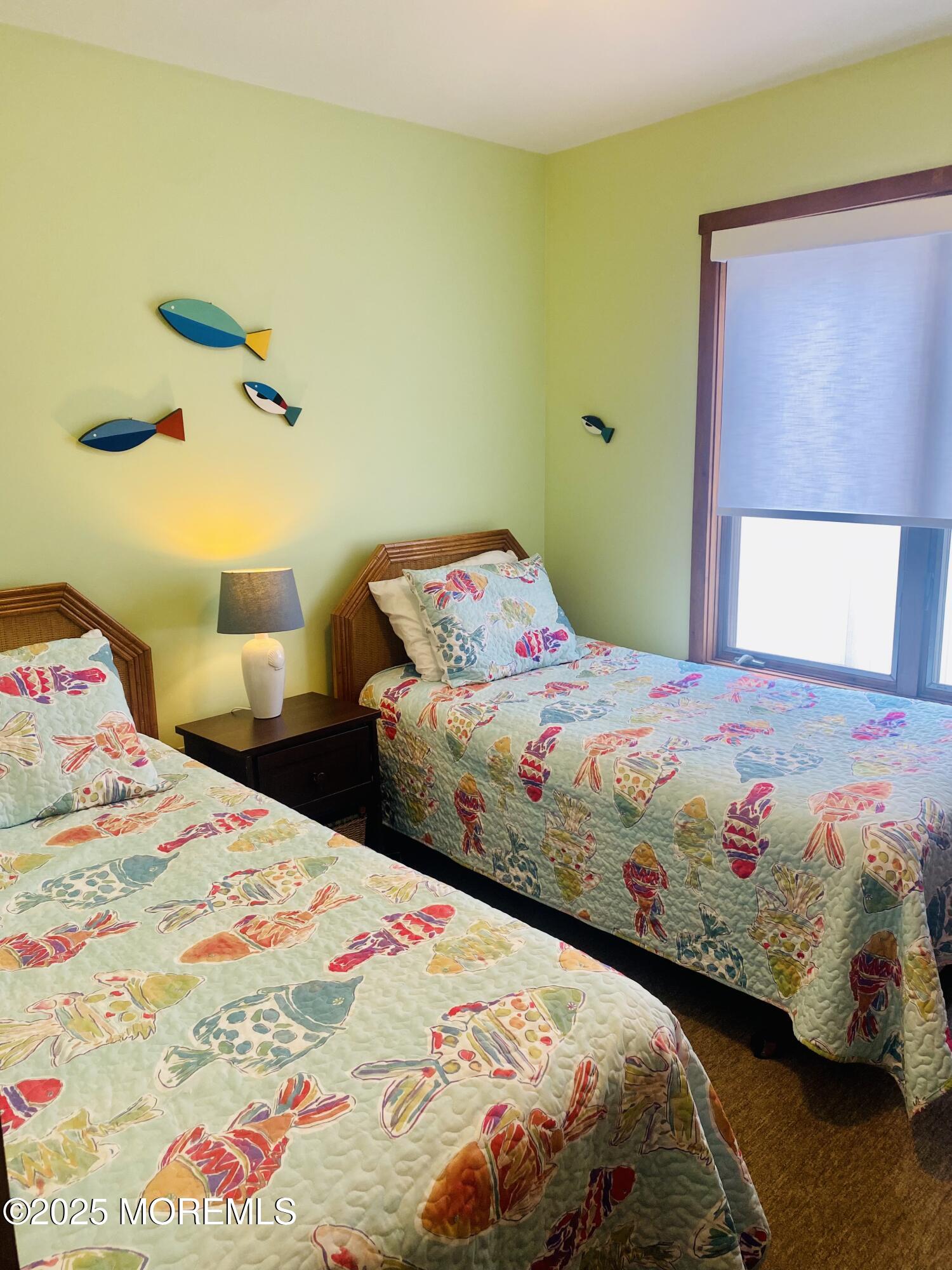 104 5th Avenue, Unit DOWN Seaside Heights, NJ 08751 - Photo 7 of 10 a bedroom with a bed and a painting on the wall