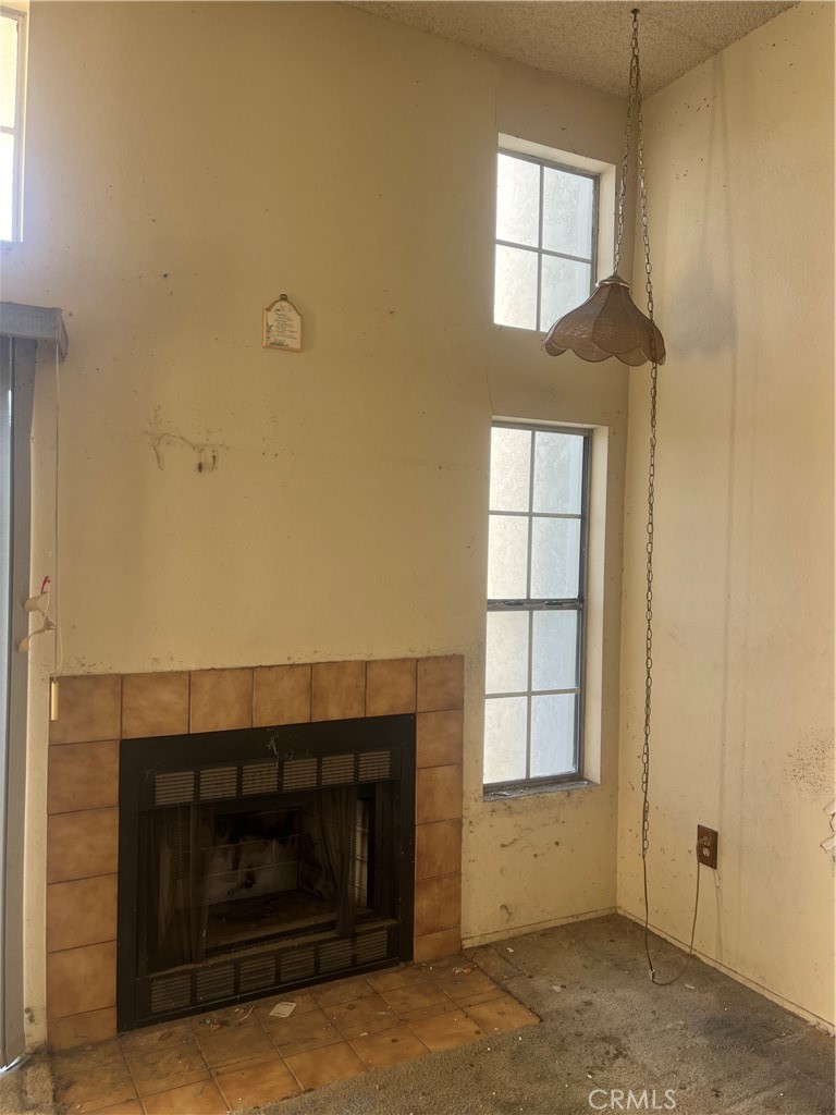 8812 Spring Canyon Drive Spring Valley, CA 91977 - Photo 19 of 22 a living room with a fireplace and a window