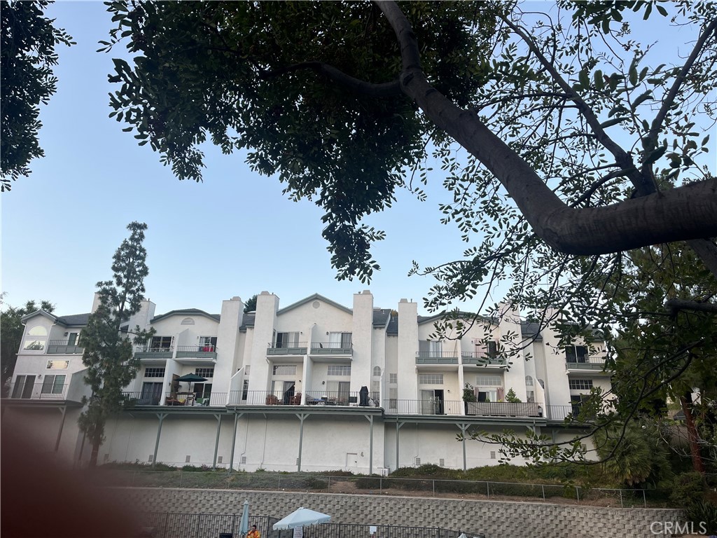 8812 Spring Canyon Drive Spring Valley, CA 91977 - Photo 2 of 22 a view of a large white building with a yard