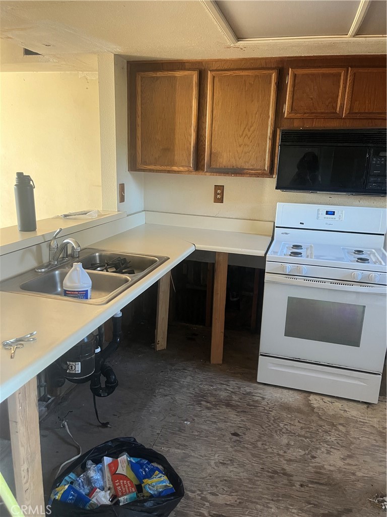 8812 Spring Canyon Drive Spring Valley, CA 91977 - Photo 10 of 22 a kitchen with a sink stove and cabinets