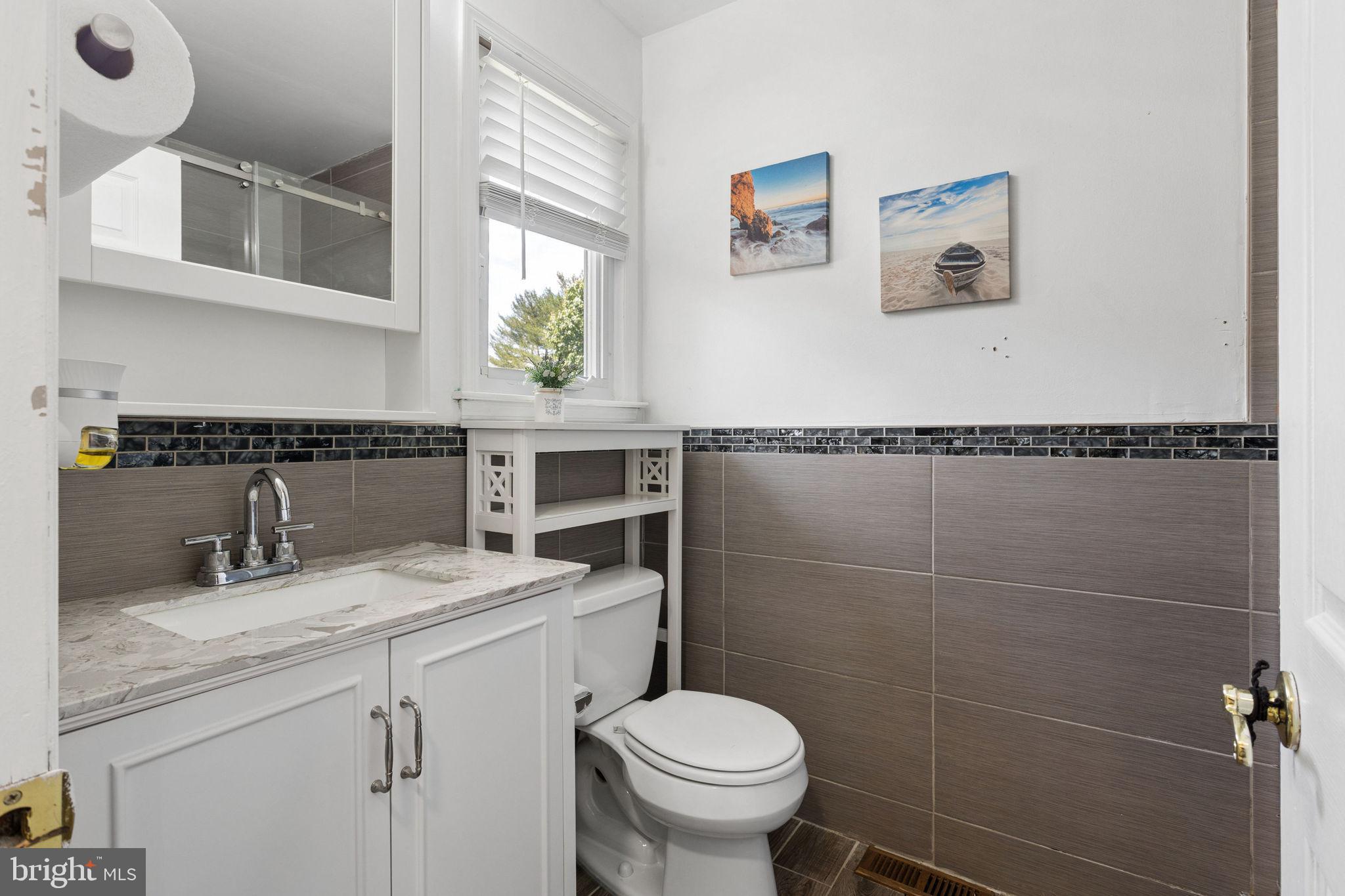 252 Sandringham Road Cherry Hill, NJ 08003 - Photo 18 of 31 a bathroom with a sink a toilet and a mirror