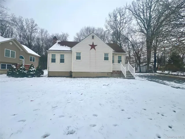 a view of house with a yard covered in snow