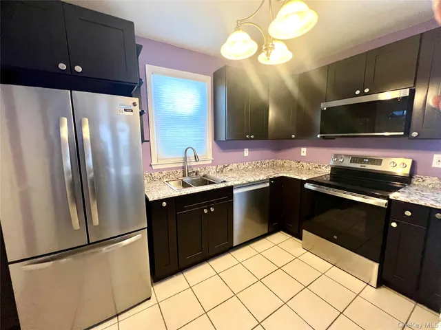a kitchen with a sink and stainless steel appliances