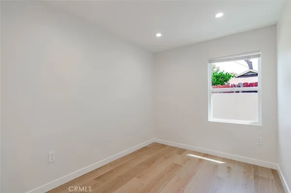 a view of room with window and wooden floor