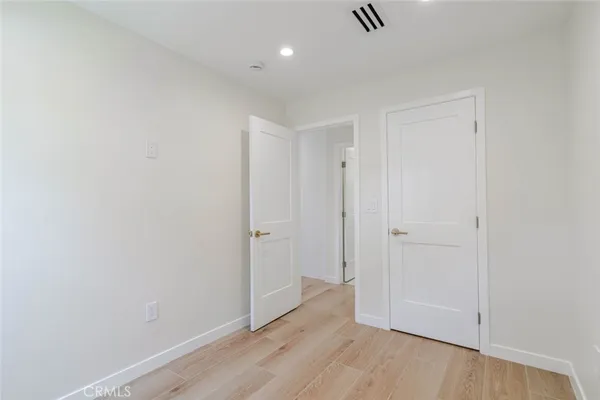 a view of hallway with wooden floor