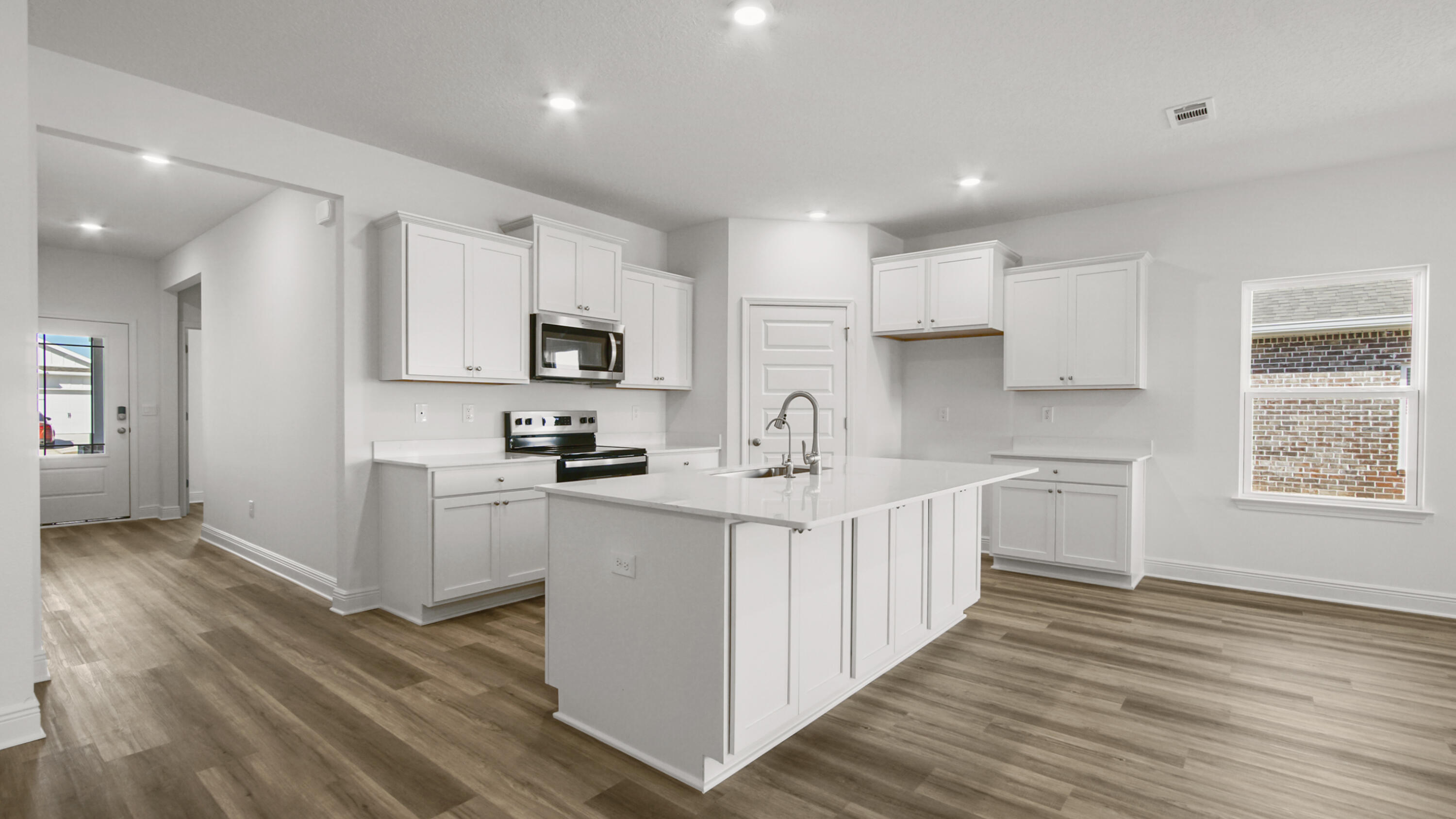 70 Gray Owl Drive Freeport, FL 32439 - Photo 5 of 20 a kitchen with white cabinets and appliances