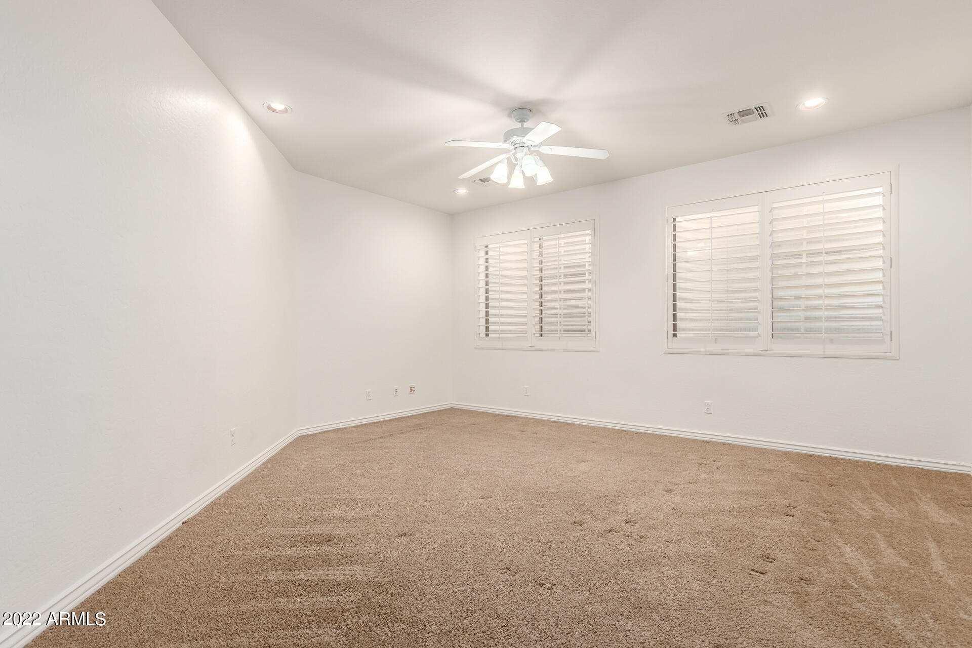4584 East Reins Road Gilbert, AZ 85297 - Photo 21 of 80 an empty room with windows and fan