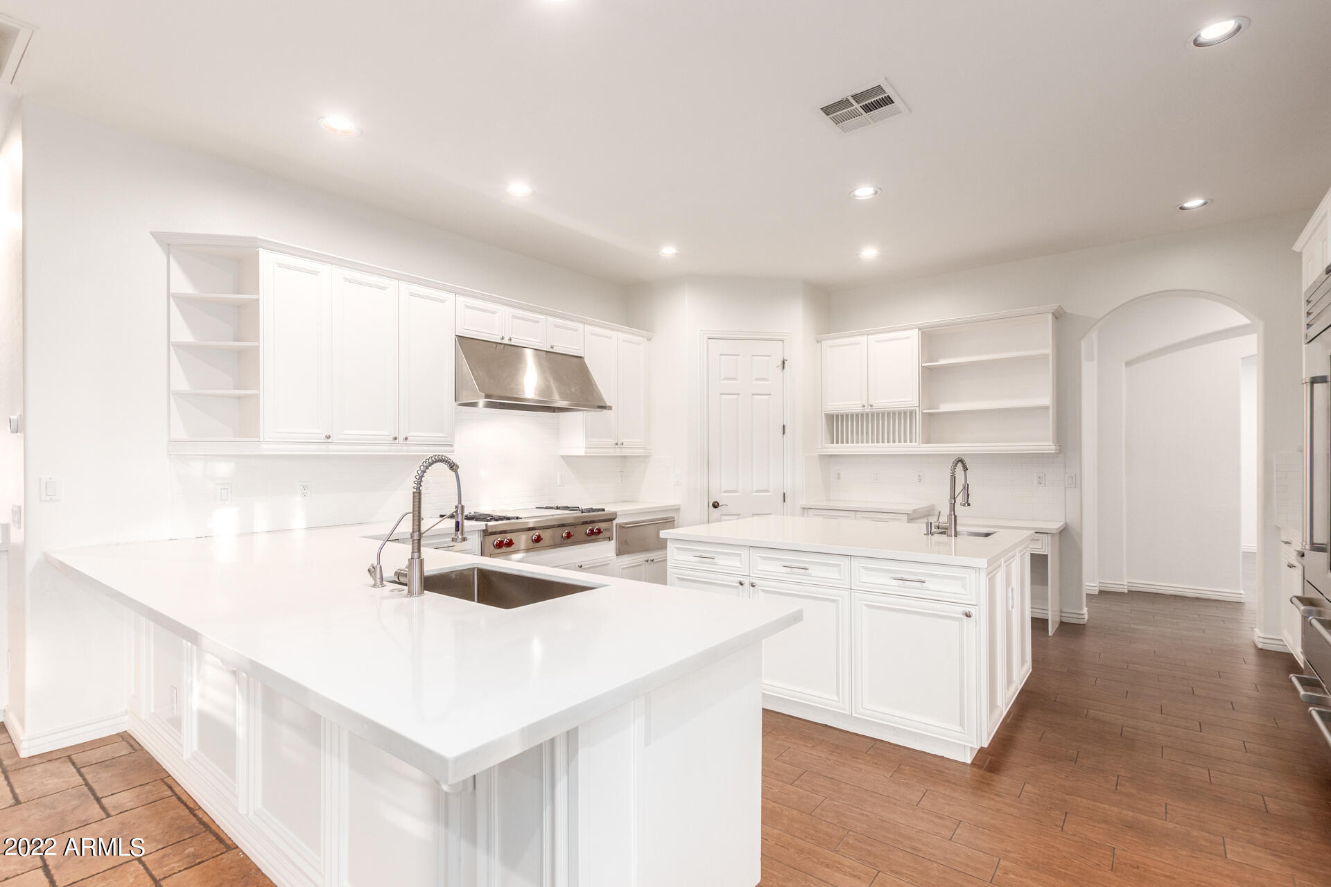 4584 East Reins Road Gilbert, AZ 85297 - Photo 5 of 80 a kitchen with a sink stove cabinets and refrigerator
