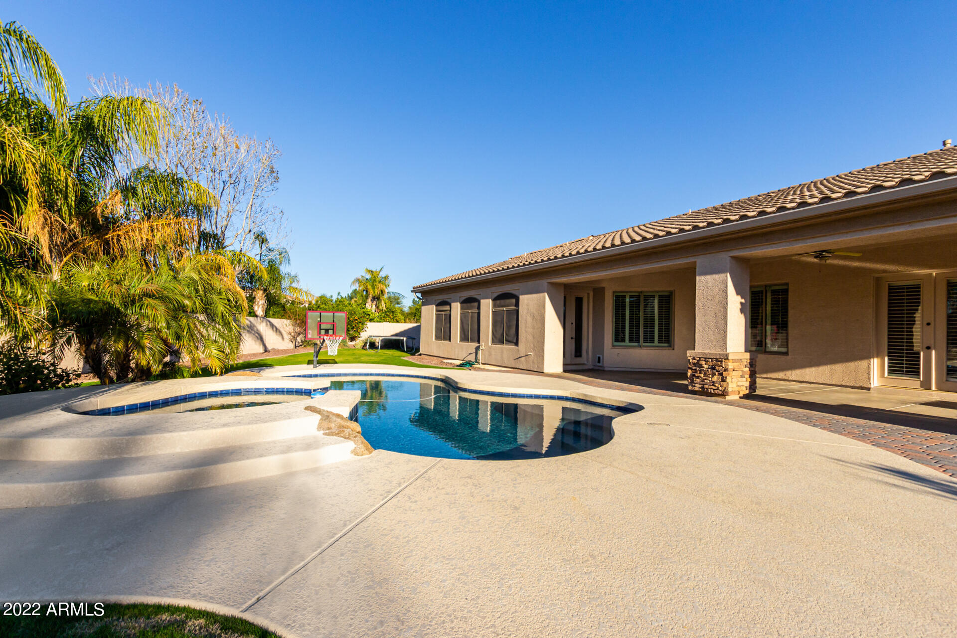 4584 East Reins Road Gilbert, AZ 85297 - Photo 51 of 80 a front view of a house with swimming pool and porch