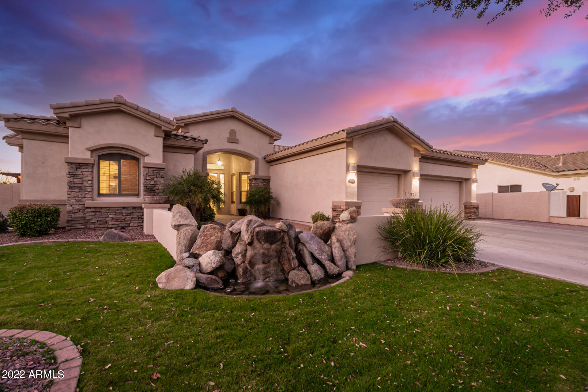 4584 East Reins Road Gilbert, AZ 85297 - Photo 60 of 80 a front view of a house with a garden and yard