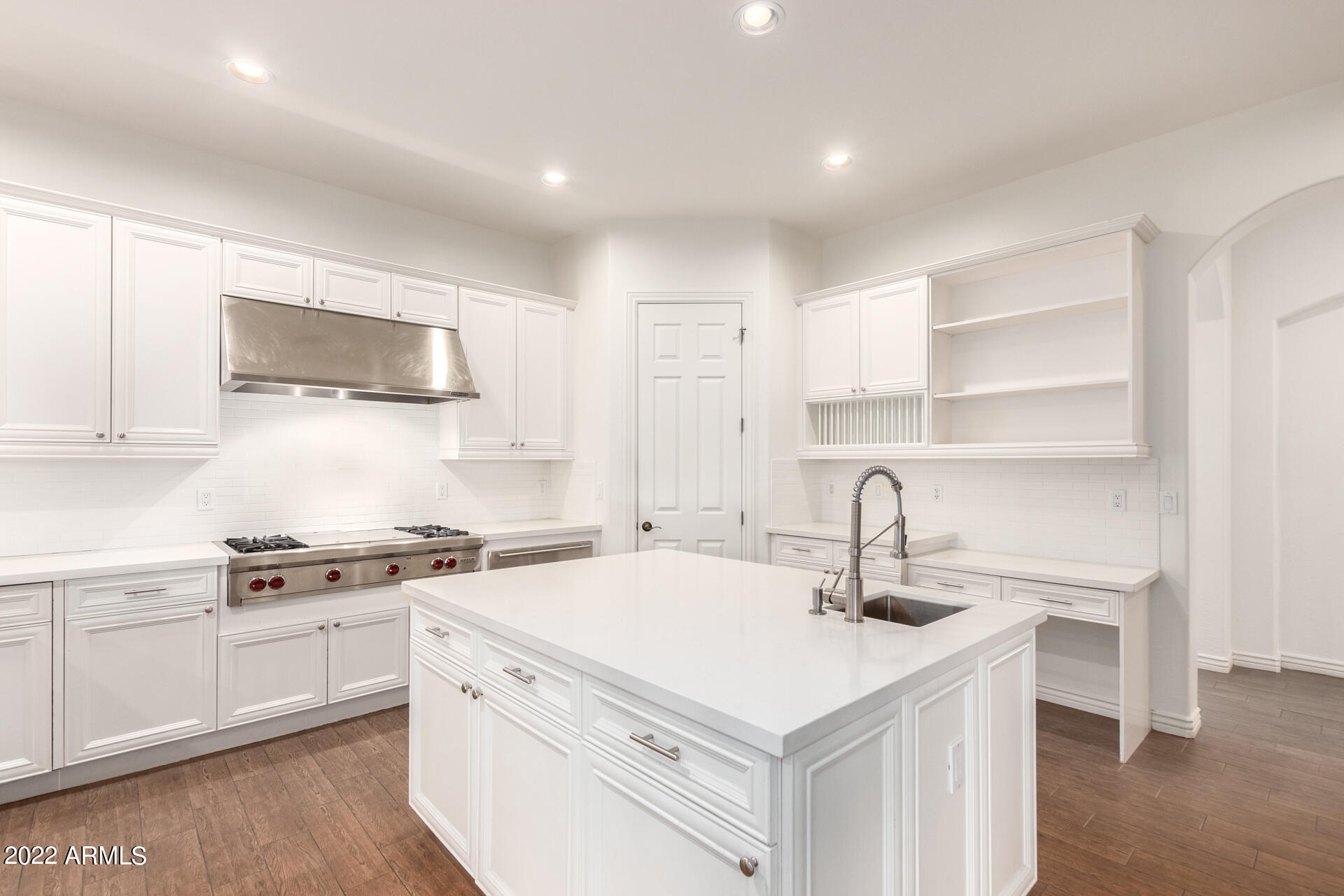 4584 East Reins Road Gilbert, AZ 85297 - Photo 6 of 80 a kitchen with a sink dishwasher a stove and white cabinets with wooden floor