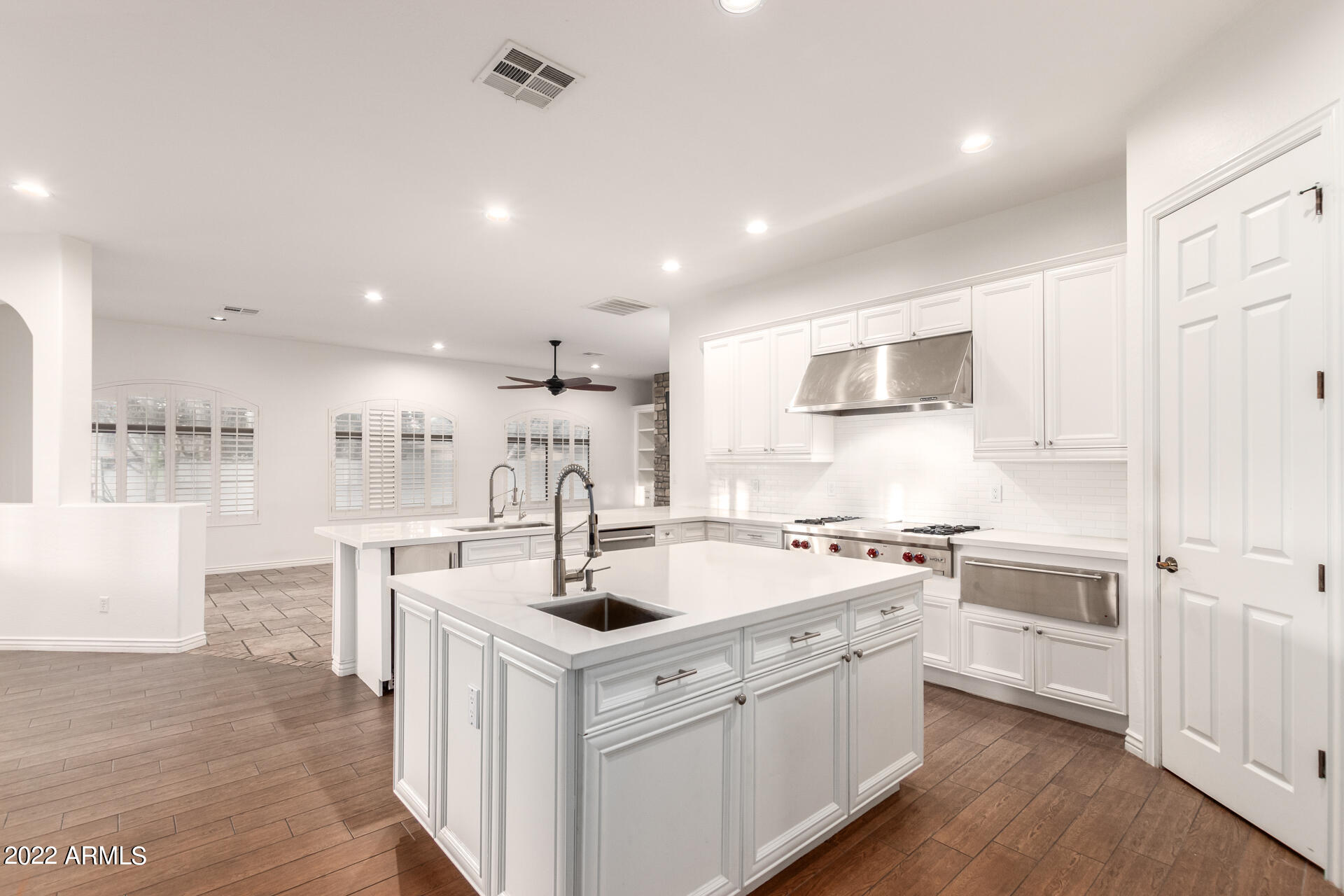 4584 East Reins Road Gilbert, AZ 85297 - Photo 7 of 80 a kitchen with a sink stainless steel appliances and white cabinets