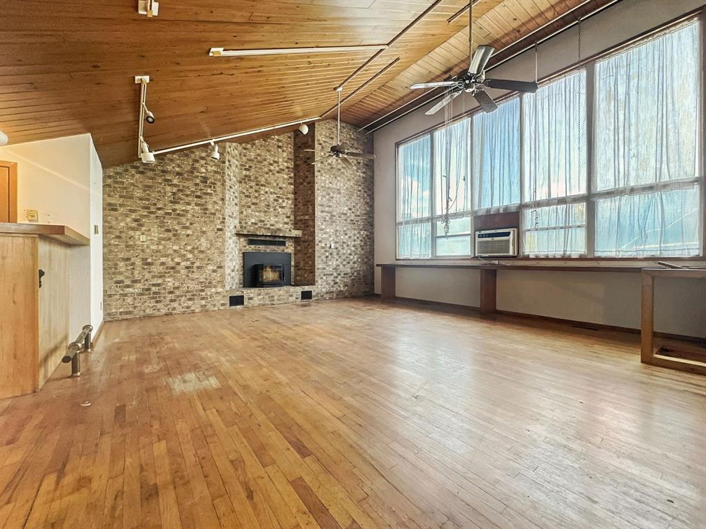 601 East Henry Street Hamilton, TX 76531 - Photo 18 of 40 a view of an empty room with a fireplace and a window