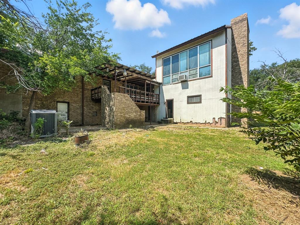 601 East Henry Street Hamilton, TX 76531 - Photo 7 of 40 a house with trees in front of it