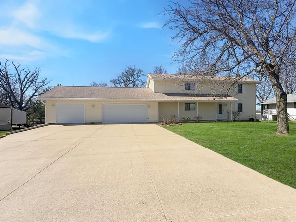 a front view of house with yard and green space