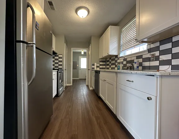 a kitchen with stainless steel appliances a refrigerator and a stove