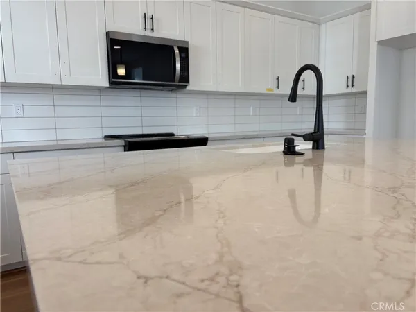 a kitchen with a sink and a stove