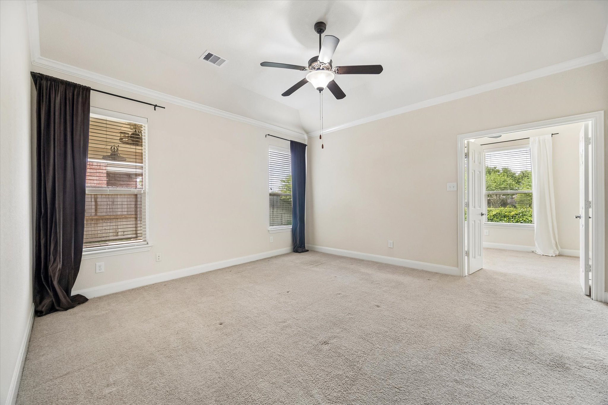 2214 Wembley Way Rosenberg, TX 77471 - Photo 24 of 35 Spacious room with light neutral wall tones, plush carpeting, and crown molding