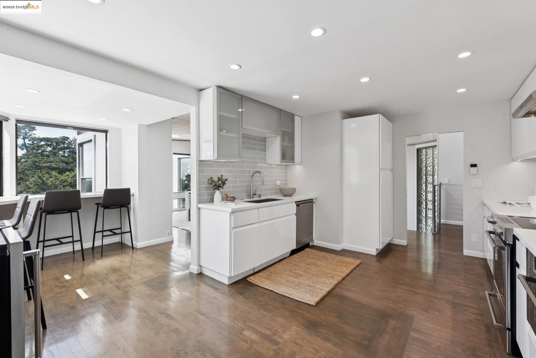 2861 Chelsea Drive Oakland, CA 94611 - Photo 18 of 56 a large white kitchen with a large window and stainless steel appliances