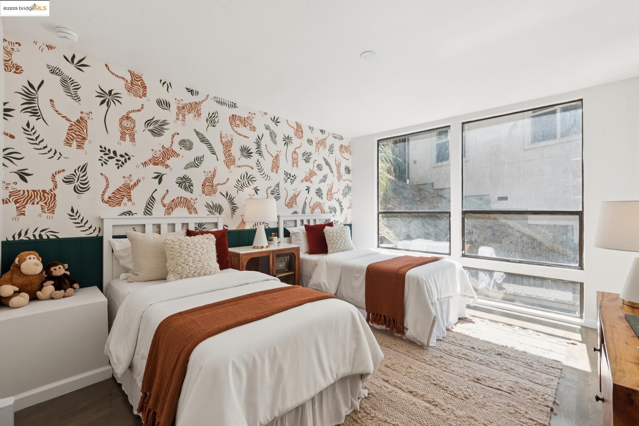 2861 Chelsea Drive Oakland, CA 94611 - Photo 39 of 56 a bedroom with two beds and a large mirror next to a window