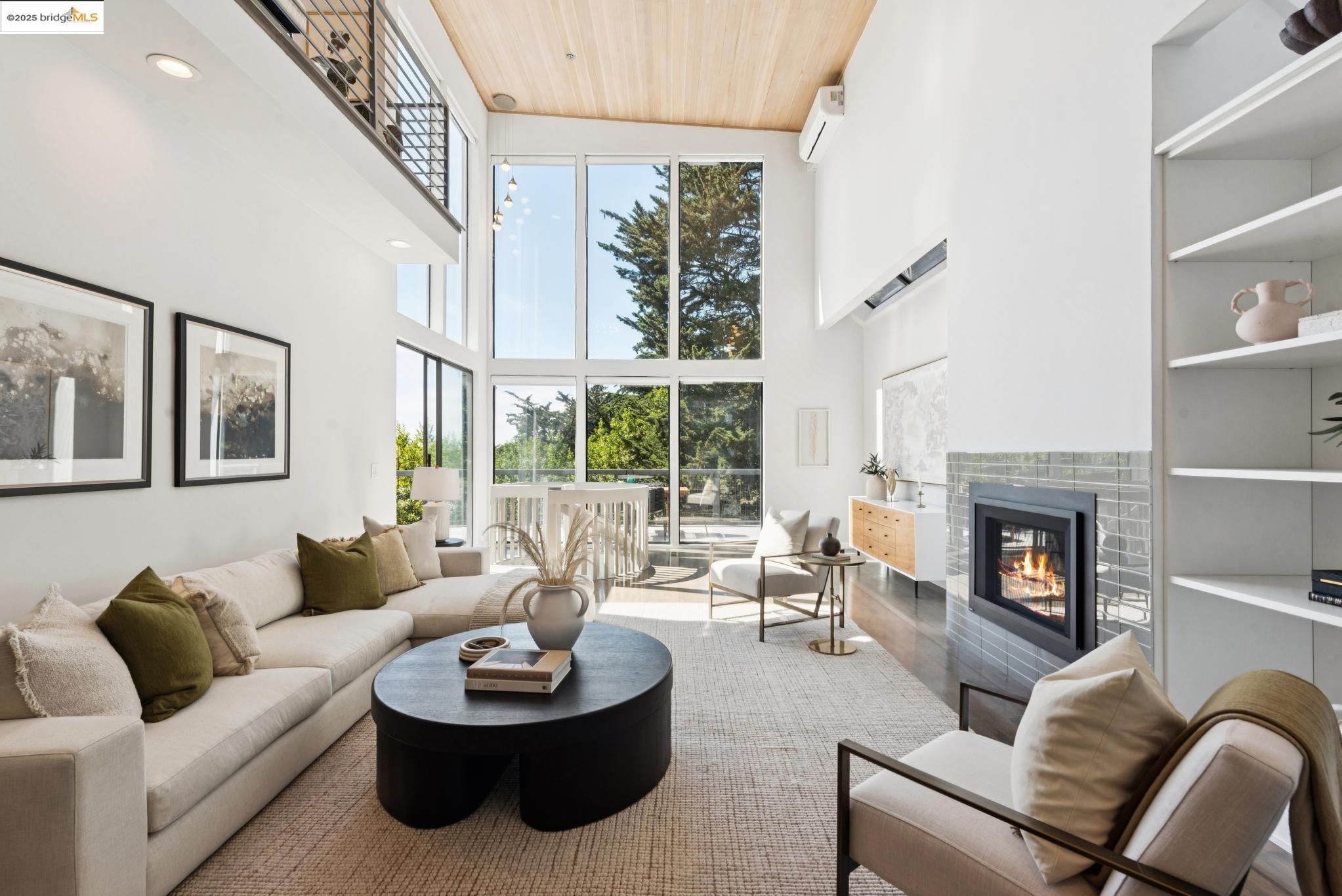 2861 Chelsea Drive Oakland, CA 94611 - Photo 4 of 56 a living room with furniture a fireplace and a large window