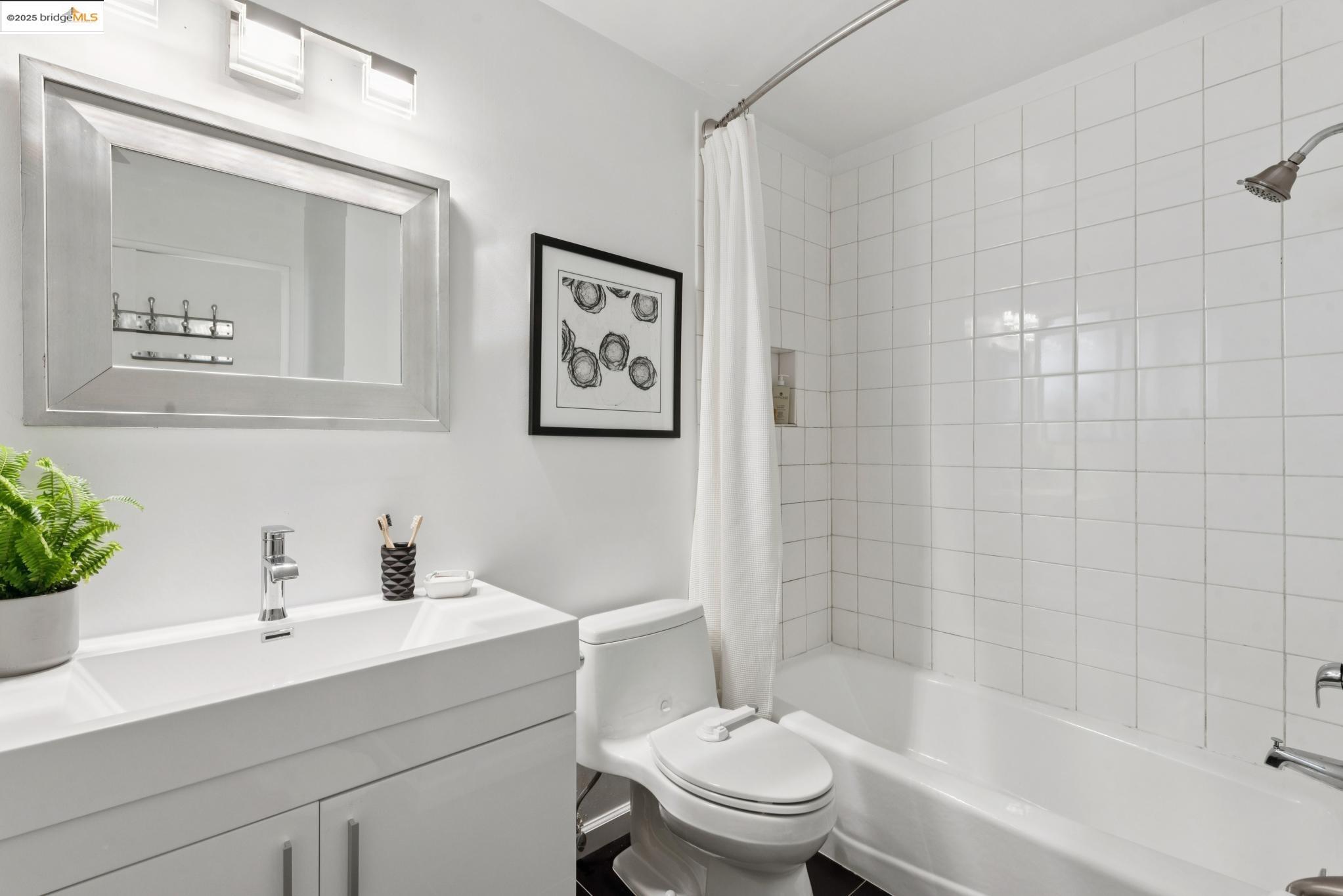 2861 Chelsea Drive Oakland, CA 94611 - Photo 41 of 56 a bathroom with a sink mirror toilet and a bathtub