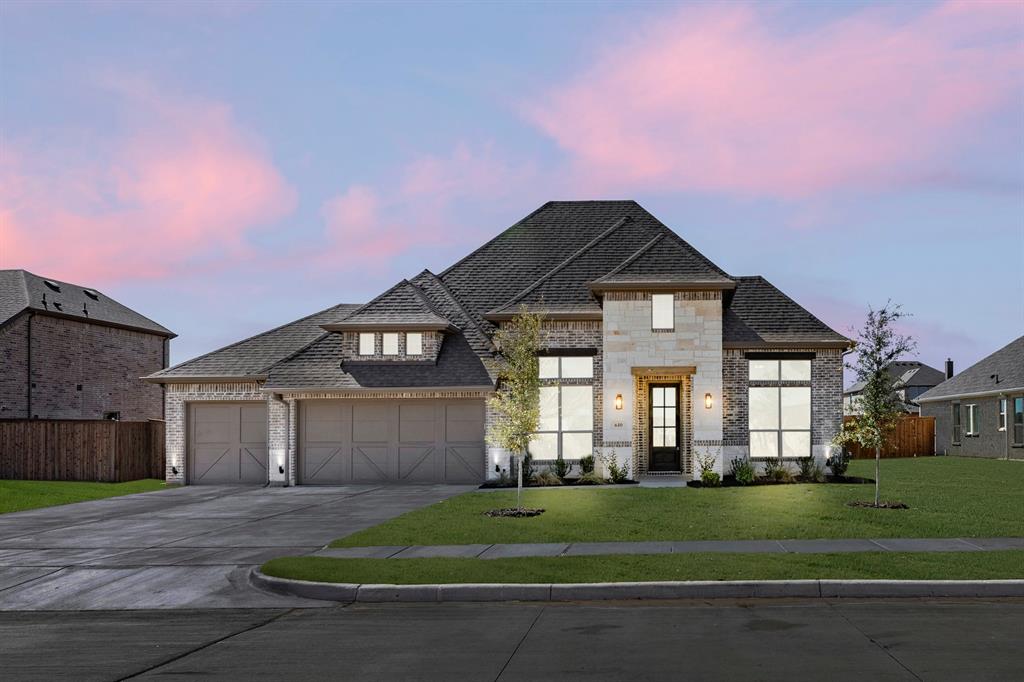a front view of a house with a yard and garage