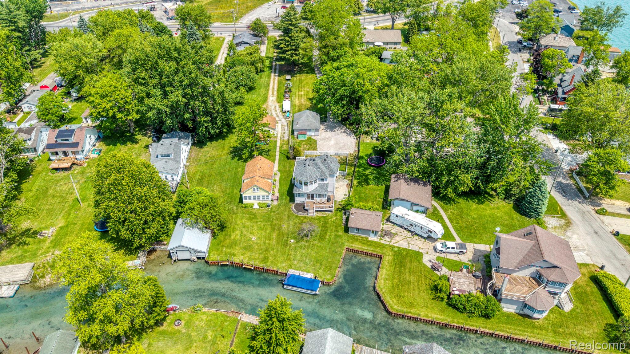 401 Pointe Tremble Road Algonac, MI 48001 - Photo 12 of 40 Waterfront property featuring a private boat house, canal access, and expansive green spaces