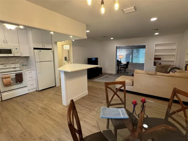 a living room with fireplace furniture and a wooden floor