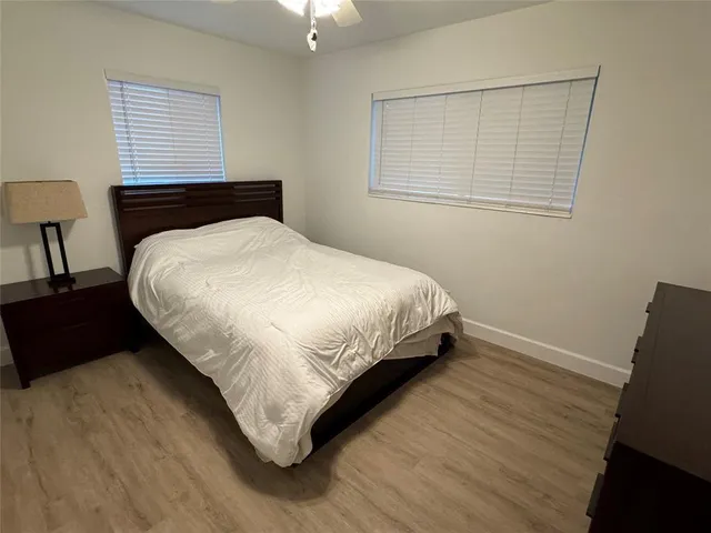 a large bed sitting in a bedroom next to a window