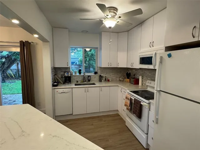 a kitchen with stainless steel appliances a refrigerator sink and cabinets