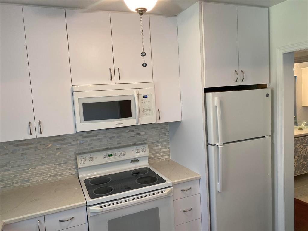 718 Northeast 5th Avenue Pompano Beach, FL 33060 - Photo 7 of 32 a kitchen with refrigerator a stove a sink and cabinets