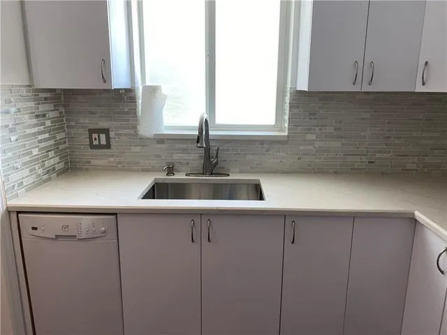 a kitchen with a sink and cabinets