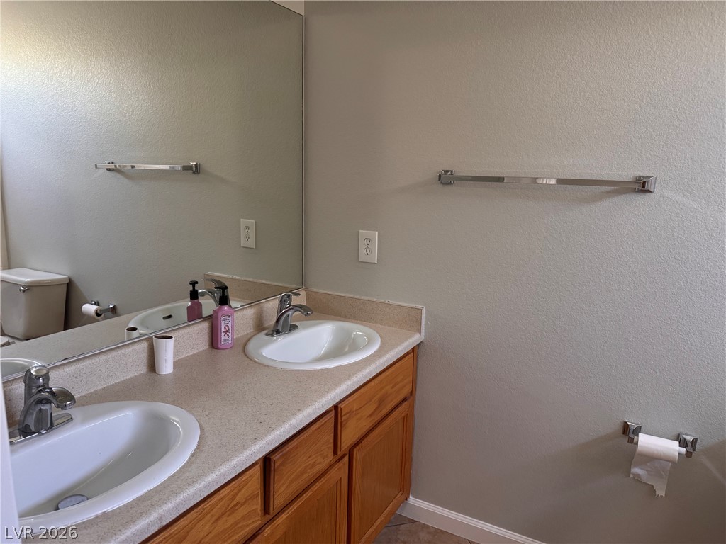8937 Austin Ridge Avenue Las Vegas, NV 89178 - Photo 19 of 22 A well-appointed primary bathroom vanity features dual sinks set in a practical countertop with ample storage.