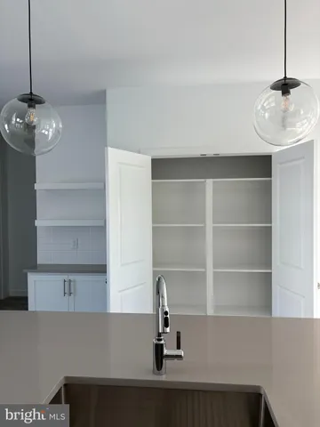 a large kitchen with kitchen island granite countertop a refrigerator and a sink
