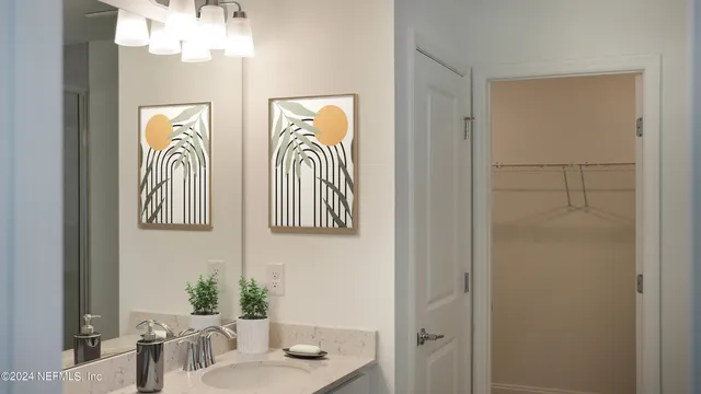 a bedroom with a bed and a potted plant