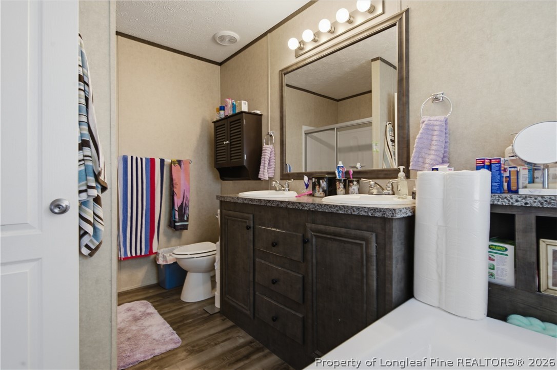 8637 Durant Nixon Road Linden, NC 28356 - Photo 12 of 36 a bathroom with a sink toilet and shower