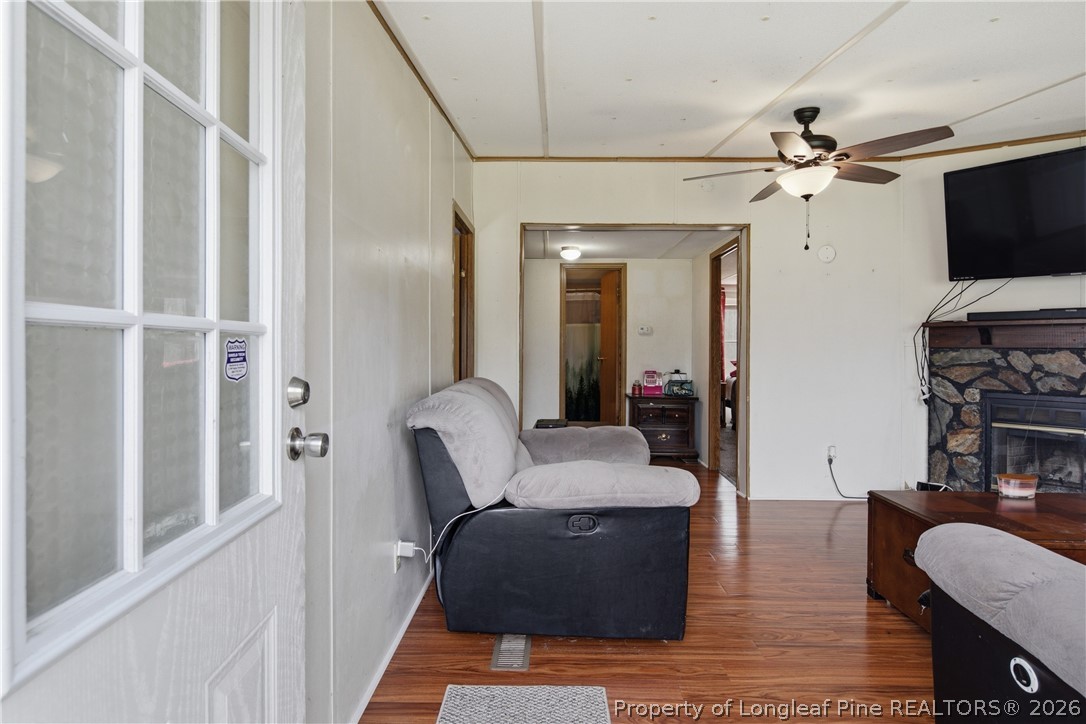 8637 Durant Nixon Road Linden, NC 28356 - Photo 16 of 36 a living room with furniture a flat screen tv and a fireplace
